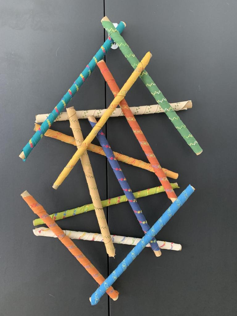 Bamboo sticks covered with various embroidered designs on fabric 1 1/2 “ x 1’