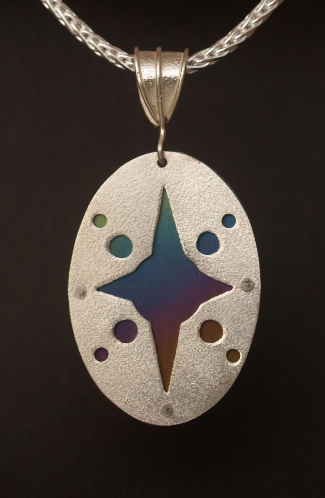 Riveted Niobium and Sterling silver starburst pendant